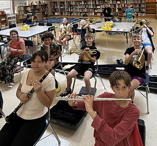 Room full of students playing musical instruments