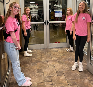 Four junior high school students looking excited