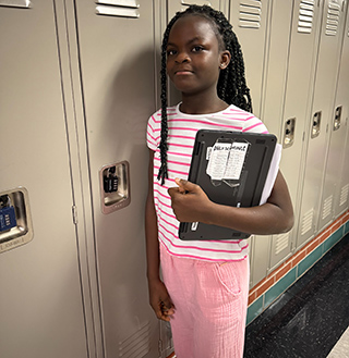 Student standing in front of her locker